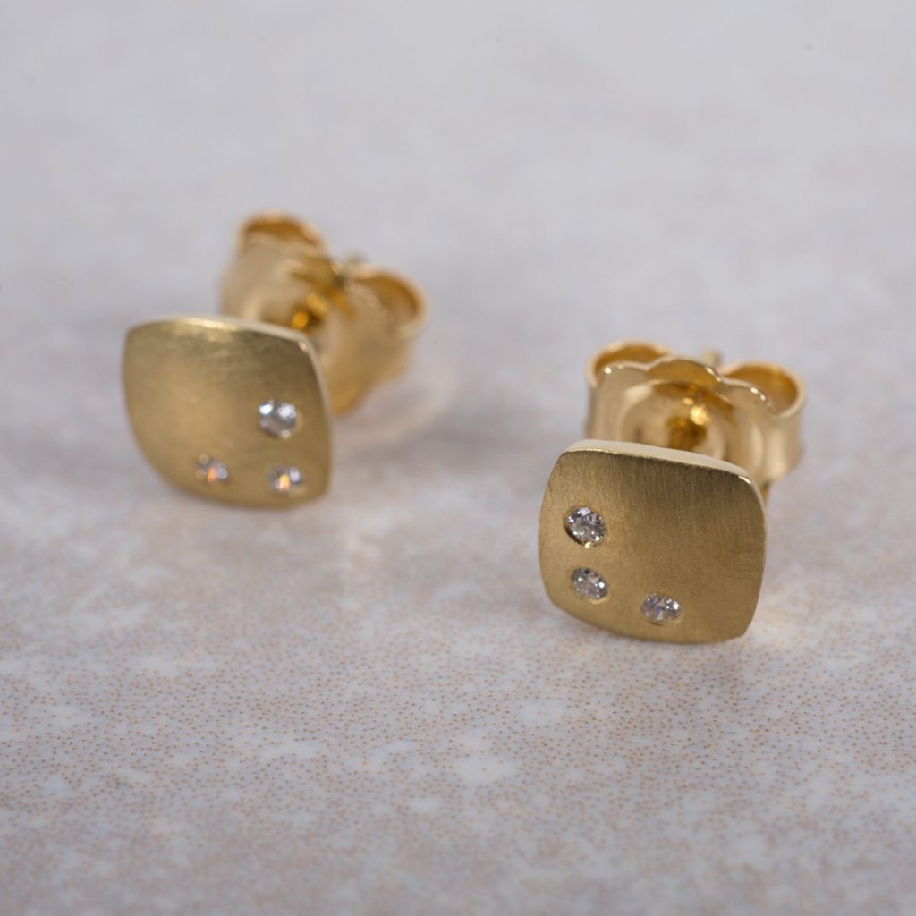 18 Carat gold Ear-studs, Textured and Gypsy set with 3 Round Brilliant cut Diamonds