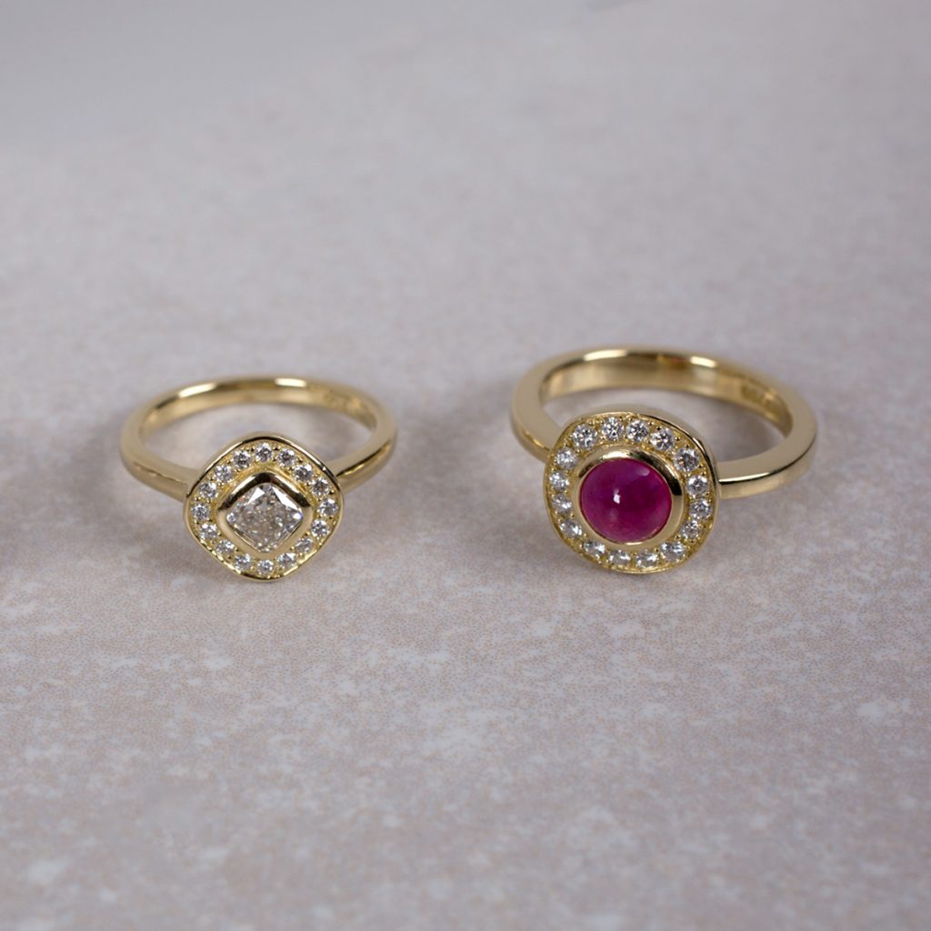 Diamond Engagement Ring beside Ruby and Diamond Ring.