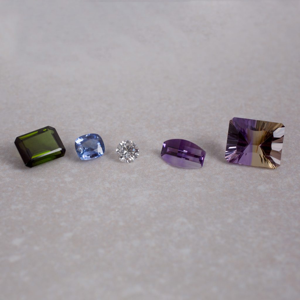 From Left to right; Tourmaline, Sapphire, Diamond, Amethyst and Ametrine.