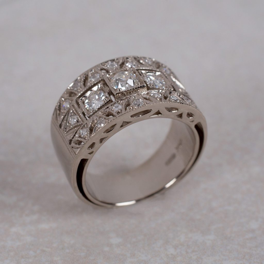 Custom Made 18 Carat Gold Art-Deco Style Ring set with 3 Old Cut Diamonds, accented with 16 Rose Cut Diamonds.