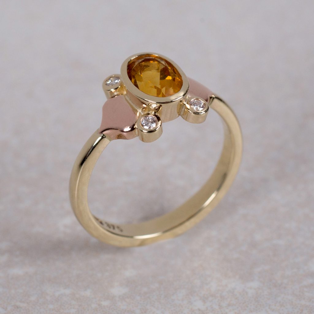 Yellow and Red Gold Dress ring set with an Oval Faceted Citrine and four round Brilliant Cut Diamonds.